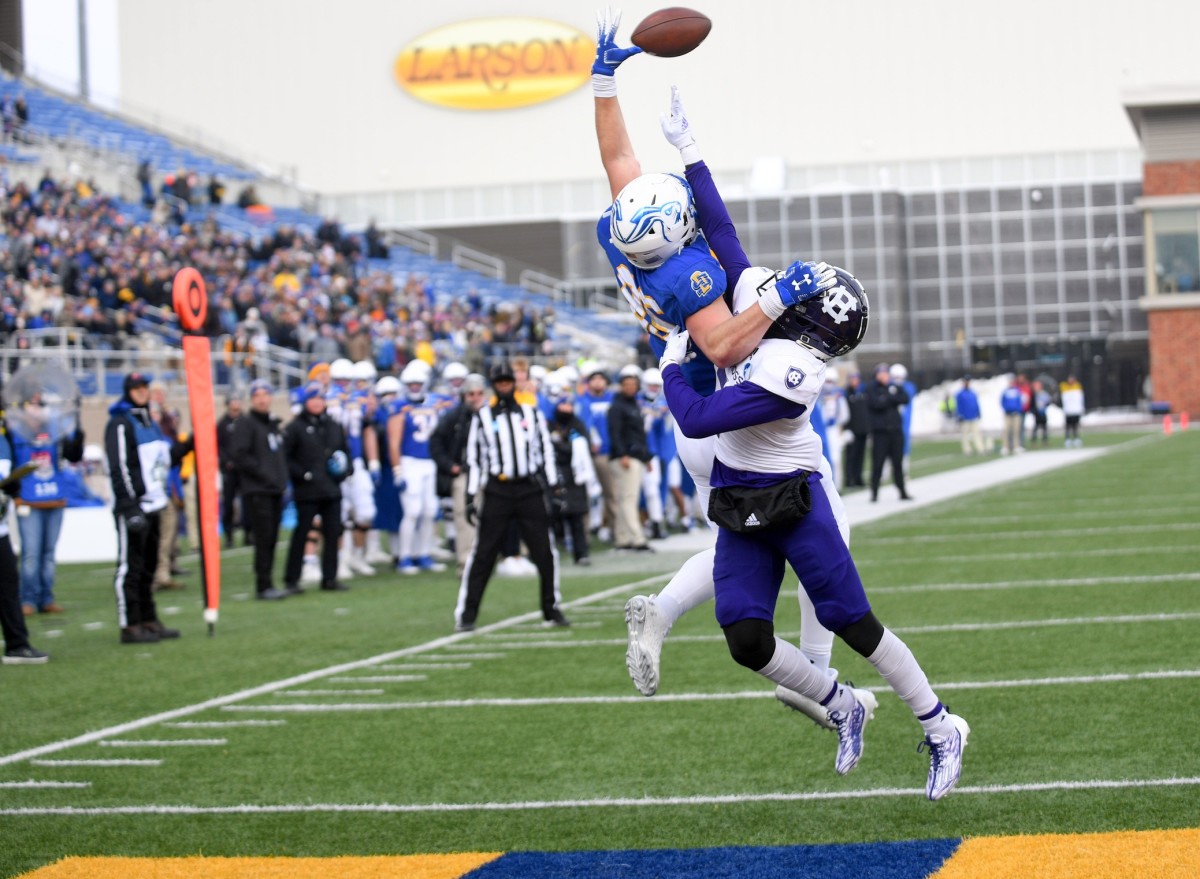 South Dakota State s Tucker Kraft leaps to catch a pass in the end zone as Holy Cross John Smith prevents him from doing so in the FCS quarterfinals on Saturday, December 10, 2022, in Sioux Falls. Fcs Quarterfinal 003